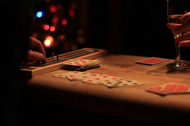 Players playing cribbage card game.