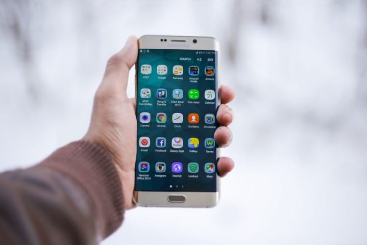 A man holding the phone in his hand.