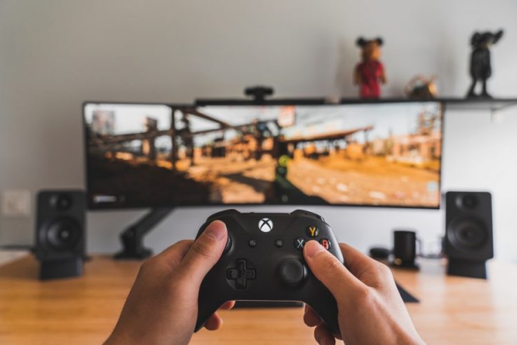 A boy playing video games with a controller.