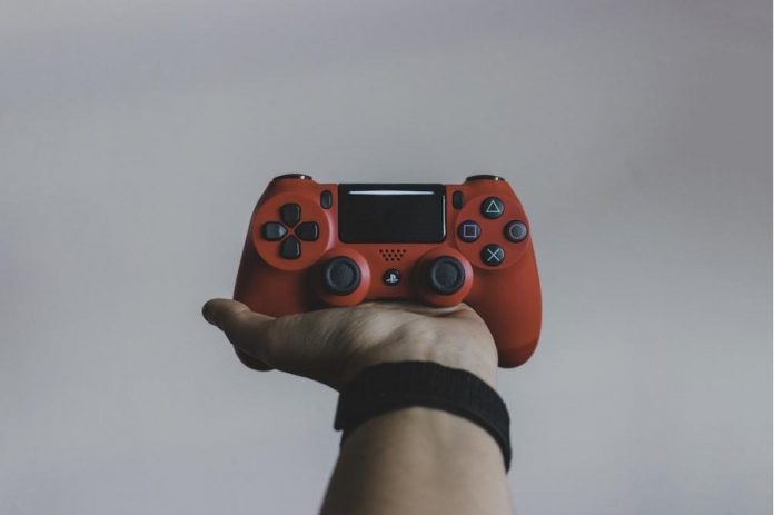 Man holding controller in his hand.
