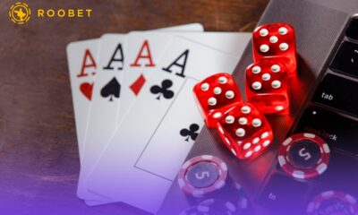 An image of playing chips, cards, and dice on a laptop