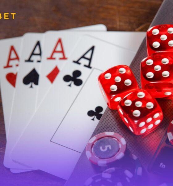 An image of playing chips, cards, and dice on a laptop