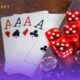 An image of playing chips, cards, and dice on a laptop